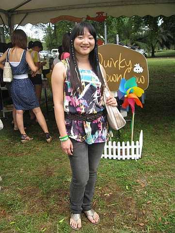 Sharon Lam wore a colourful sleeveless top with patterns that were remiscent of the 1980s and paired it with jeans and a weaved belt.