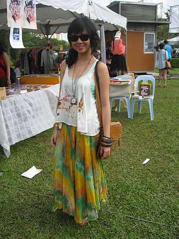 Cynthia Ong paired a tie-dyed long skirt with a racerback as well as a loose top, adorning her wrists with ethnic-inspired bangles.