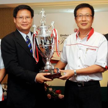 Chan (left) wasn't a football fan before becoming Cardiff City chairman, but is now doing his part to develop Malaysian junior football. He is pictured here at a trophy presentation ceremony for the Yamaha Junior Football League.