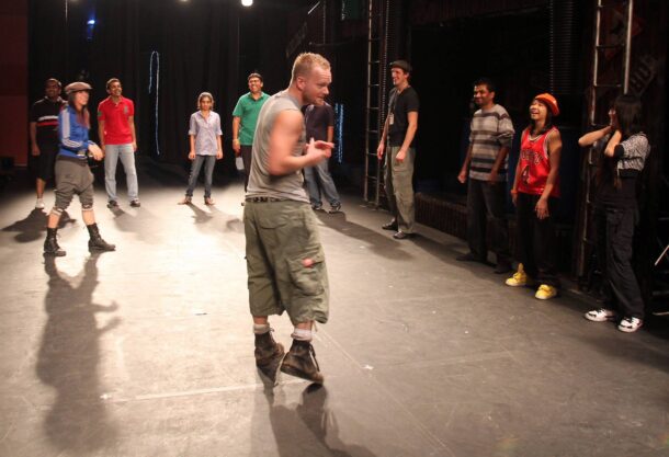 Participants look on as Peter shows them his moves.