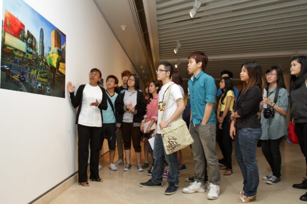 Angelina Chong Curator Angelina Chong (far left) giving students a walkthrough of the exhibition.