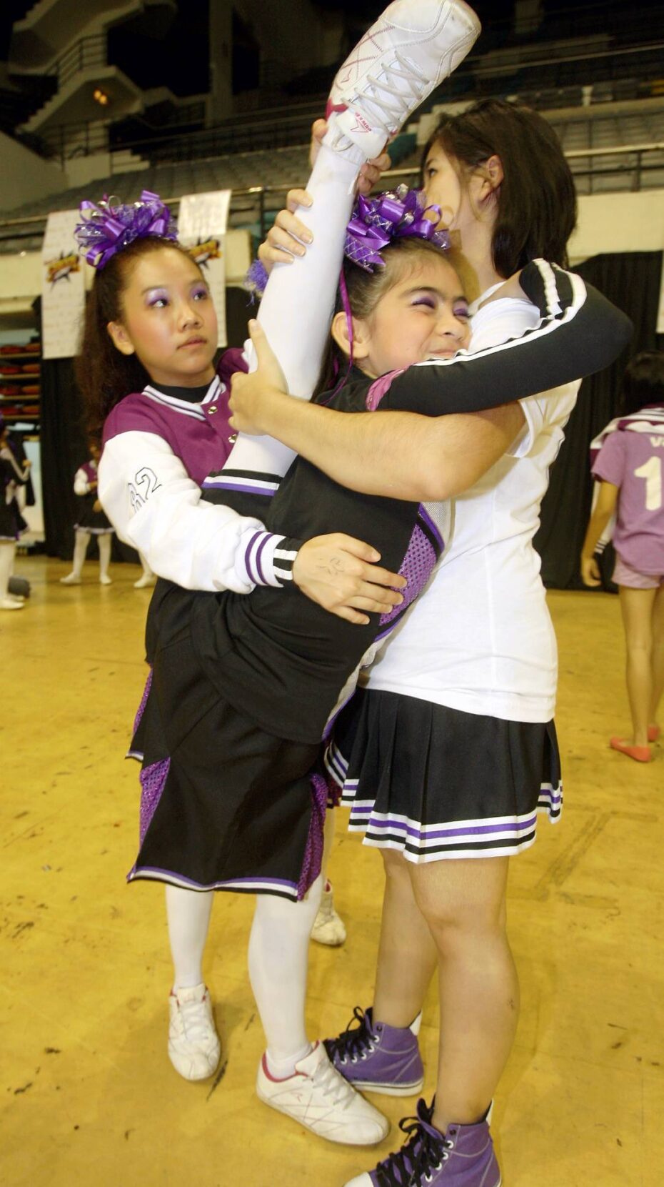Now THAT'S what you call a stretch! Team Vibrant cheerleaders, from SMK Puteri Titiwangsa, Kuala Lumpur, warming up ahead of day one of the two-day finals.