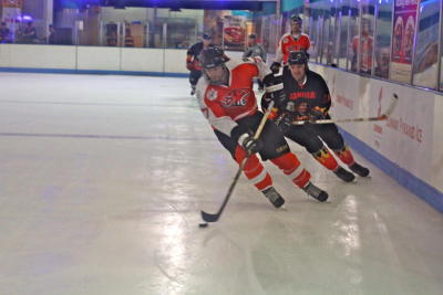A HK Tiger and Singapore Manimal vying for the puck at the Malaysia International Ice Hockey Tournament in Sunway Pyramid.