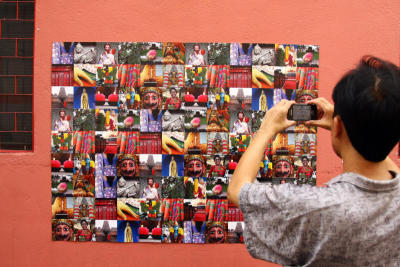 One of the participants taking photo of a collage depicting the various cultural celebrations around Brickfields, KL.