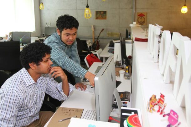 Fariz showing us around Motiofixo while working with his teammates.