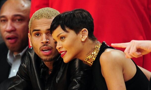 Rihanna (R) and Chris Brown attend a game between the New York Knicks and the Los Angeles Lakers during the NBA game at Staples Center in Los Angeles, California, on December 25, 2012.