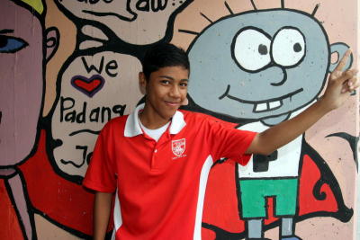 Mohd Fitri Mifdal, 15, standing against his artwork on mural painted underneath a flyover at Kampung Padang Jawa in Shah Alam, Selangor.