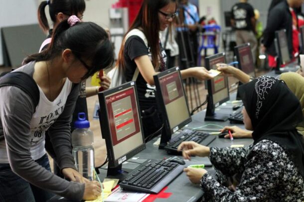 Students registering to vote during the campus elections at counters at Kolej 13 at Universiti Putra Malaysia.