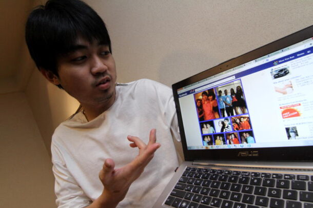 Political activist Shen Yee Aun showing a derogatory Facebook banner with photos copied from his personal Facebook account. Shen claims they are the work of political 'cybertroopers'.