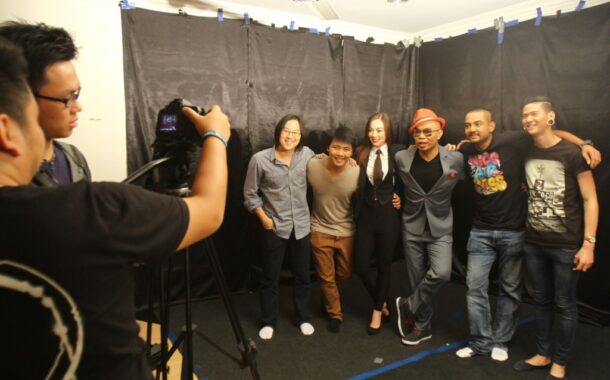 From left: R.AGE editor Ian Yee and journalist Kevin Tan (right) posing for a photo with the cast of the Keep On Keepin' On music video. The song was written and produced by Liang (third from right) in support of R.AGE and Nick Vujicic's anti-bullying campaign.