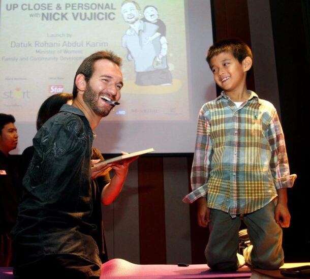 Nick Vujicic signing a book for a young fan during the Q&A session of his 'Up Close & Personal with Nick Vujicic' talk in PJ Hilton, Selangor.