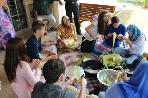 One of the host families teaching the AFS exchange students in Kedah how to weave ketupat during Hari Raya.