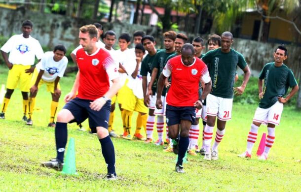 QPR Community Trust members Stephen McCarthy (in red, left) and Martino Chevannes (in red, right) coaching some of the students at SMK Seksyen 11, Shah Alam.