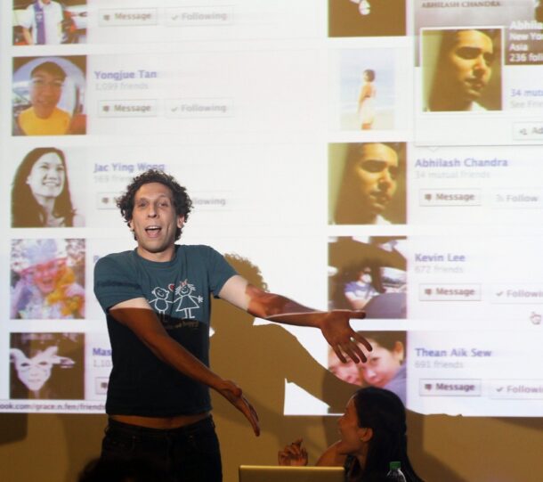 American performance artist Brian Lobel going through his Facebook friends list during Purge, a project that examines modern friendships through social media.