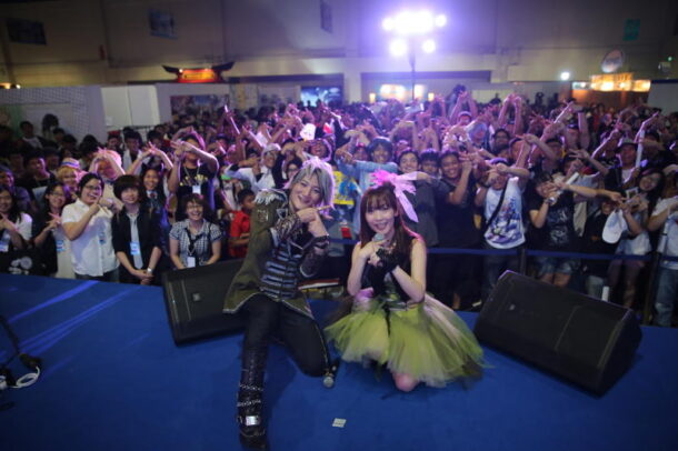 Dynamic duo: Angela posing with their Malaysian fans after an electrifying performance at the Animax Carnival.