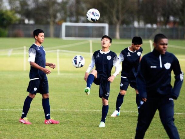 The winners of the AirAsia QPR Coaching Clinic from Malaysia and Singapore going through some drills at the QPR academy in London.