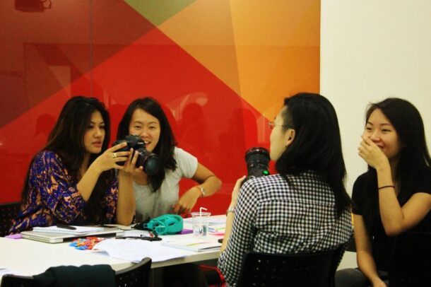 Participants of the Journalism for Social Good video journalism workshop at the British Council getting hands-on with their cameras during a workshop session.