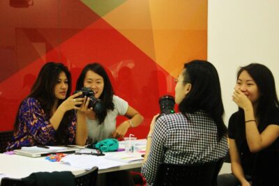 Participants of the Journalism for Social Good video journalism workshop at the British Council getting hands-on with their cameras during a workshop session.