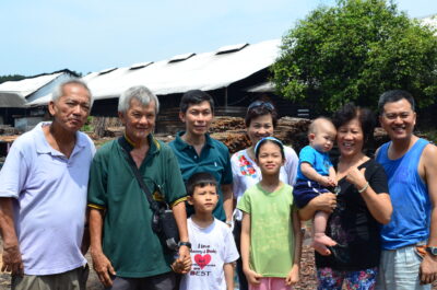 Meet the Chuahs: Chuah Kee Yong, 43, (right) and (from left) his uncle Chuah Chow Aun, 67, and his father Chuah Cheow Seng, 70, pose with their family at the charcoal factory.