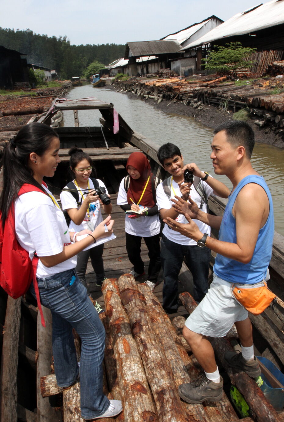 Chuah Kee Yong, 43, explains the process of making charcoal and the history behind his family’s business to a few BRATs members.