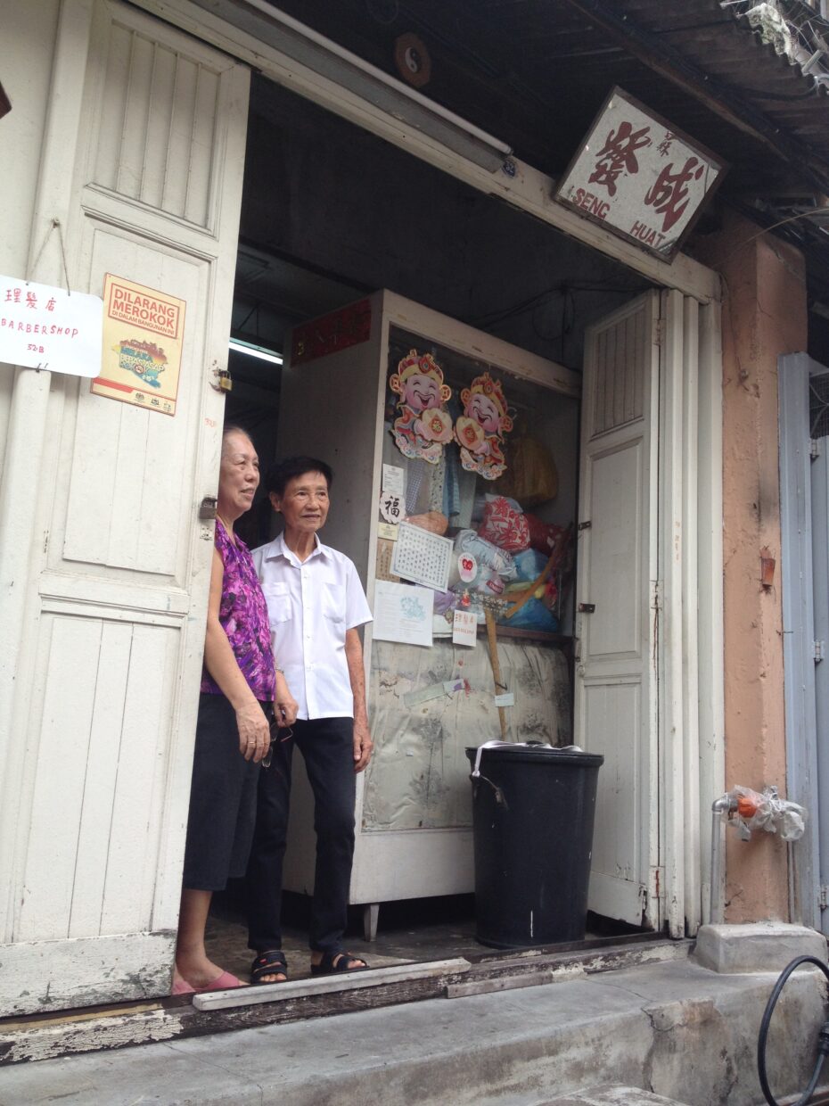 BFFs: Tailor Kan Yuan Lin, 77, and barber Soo Xiu Keng, 78, have run their businesses side-by-side in this narrow shop off Jonker Street for 58 years.