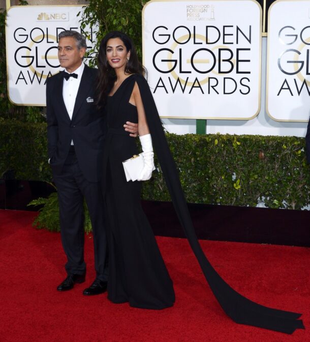 George Clooney poses with wife Amal on the red carpet at the 72nd Annual Golden Globe Awards, where he was awarded the lifetime achievement award. -- Photo by EPA.