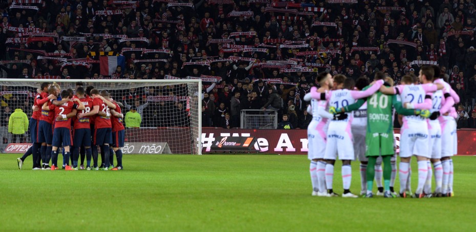 At a football match between French clubs Evian and Lille, where a minute's silence was observed. -- Photo by AFP