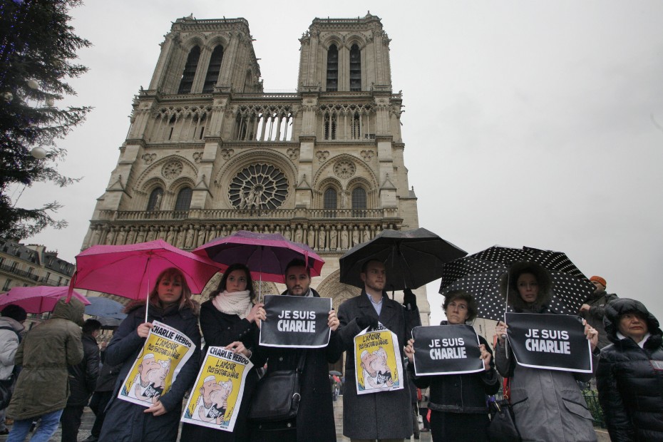 People in Paris stood in front of Notre Dame Cathedral when France observed a minute of silence today in honour of the 12 people killed. - Photo by AFP