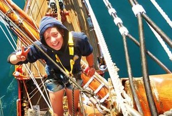 Burger hanging from the rig of a Bark Europa tall ship, where she worked as a deck hand, sailing from Cape Town to Durban.