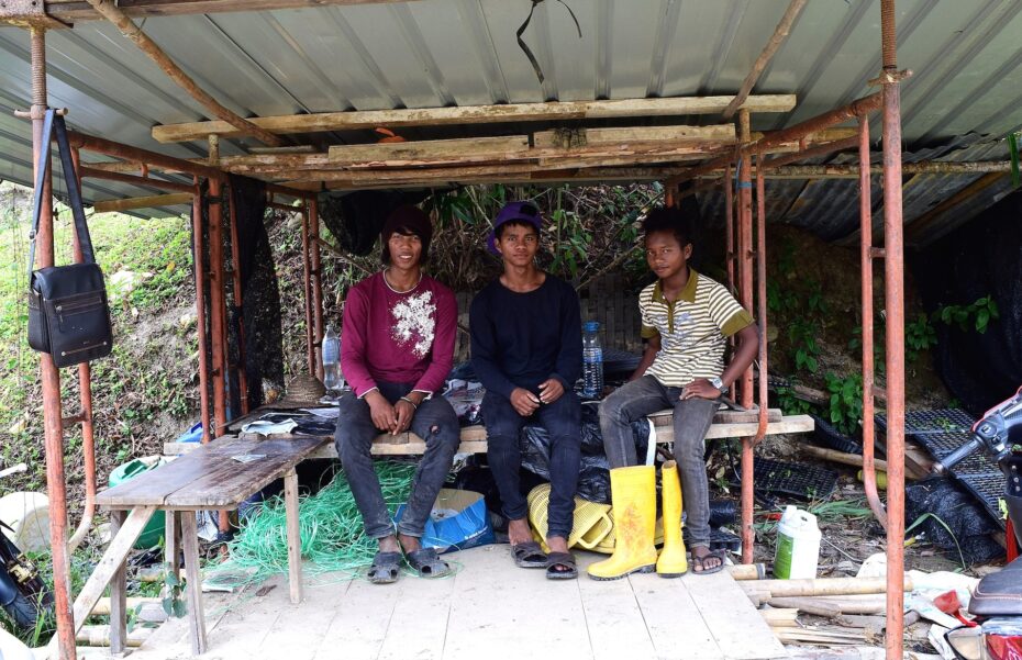 During their break, (from left) Zofian and his co-workers Atiaz and Ramli rest under a shed.