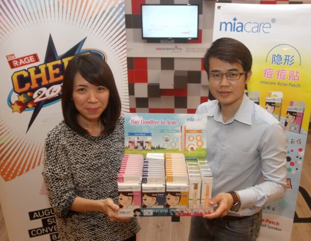 Star Media Group Berhad account servicing executive Ng Bi Yan (left) with BenQ regional sales manager Neo. BenQ is the manufacturer of Miacare Acne Patch, which will be given away at CHEER 2015 and promises to combat blemishes. - SAMUEL ONG/The Star