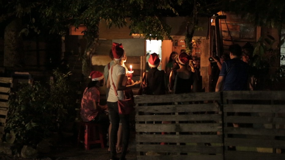 The carollers singing outside of Mariyammah's home