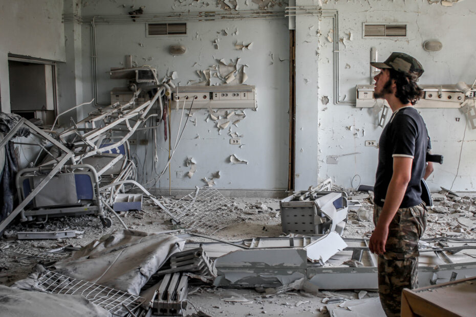 A man surveys the remnants of a Syrian hospital after an airstrike. Lau hid in the basement with the hospital staff until it was over. Photo: Chris Lau.